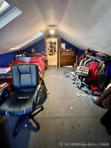 bedroom with lofted ceiling with skylight