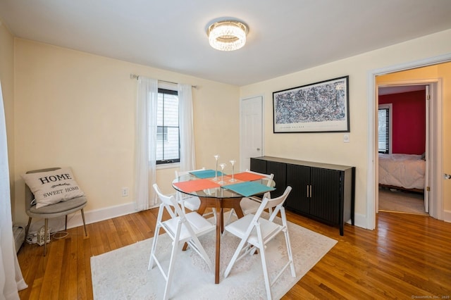 dining space with wood finished floors and baseboards