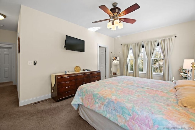 bedroom with baseboards, visible vents, a ceiling fan, and light colored carpet