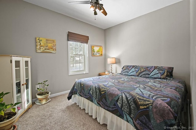 carpeted bedroom with ceiling fan and baseboards