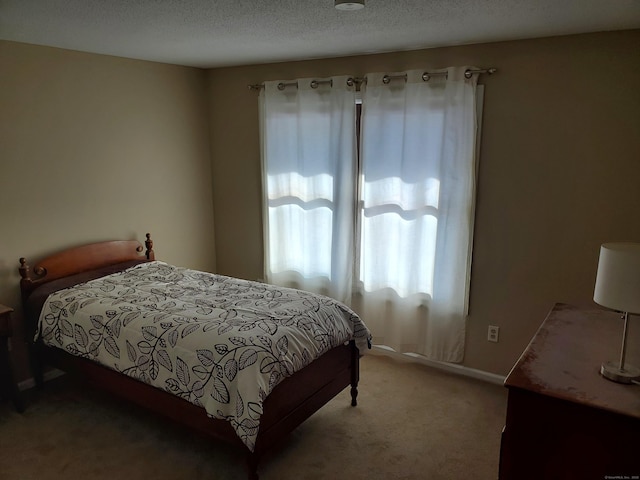 bedroom with a textured ceiling and carpet flooring