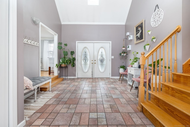 entrance foyer with ornamental molding, stairway, and baseboards