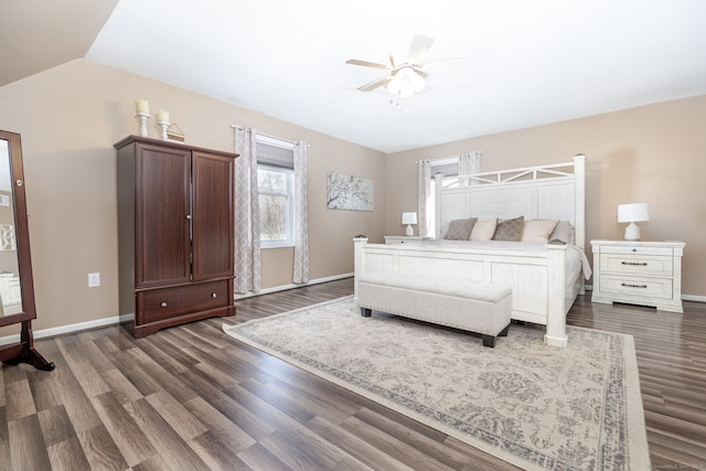 bedroom featuring lofted ceiling, baseboards, and dark wood-type flooring