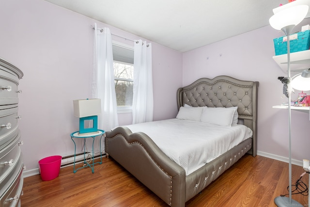 bedroom featuring wood finished floors and baseboards