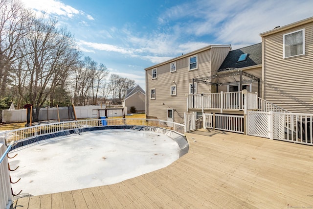 exterior space featuring fence and a wooden deck