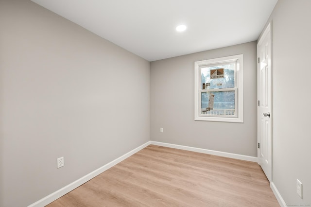 empty room with light wood-style floors and baseboards