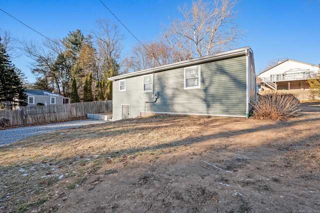 rear view of property with fence