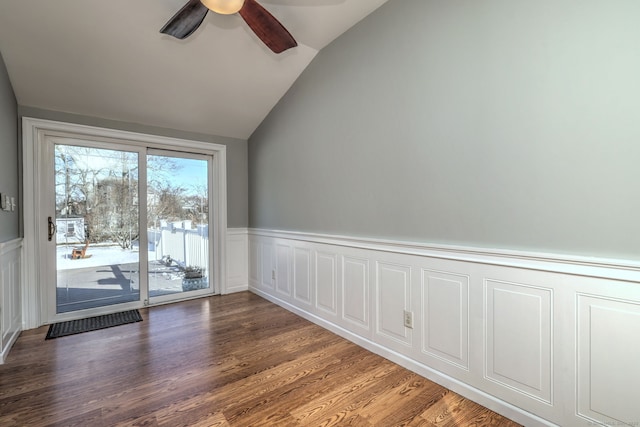 spare room featuring lofted ceiling, dark hardwood / wood-style floors, and ceiling fan