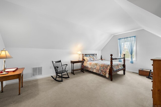 bedroom featuring vaulted ceiling, baseboards, visible vents, and light colored carpet