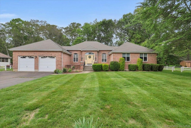 101 Langford Ln, East Hartford, CT 06118 - view of front of property with an attached garage, asphalt driveway, brick siding, and a shingled roof