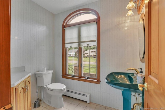 101 Langford Ln, East Hartford, CT 06118 - bathroom featuring a baseboard heating unit, tile walls, tile patterned floors, and toilet