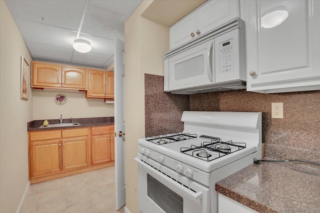 101 Langford Ln, East Hartford, CT 06118 - kitchen featuring white appliances, a sink, a drop ceiling, dark countertops, and tasteful backsplash