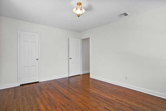 unfurnished bedroom featuring dark hardwood / wood-style flooring