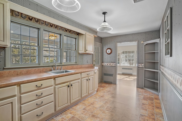 kitchen with sink, radiator, and pendant lighting