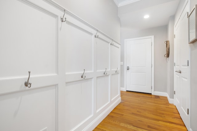 hallway with light wood-style floors, baseboards, and recessed lighting