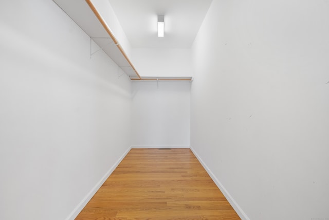 walk in closet featuring light wood finished floors