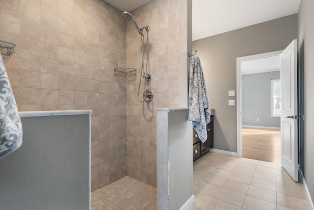 bathroom featuring tile patterned flooring, baseboards, and walk in shower