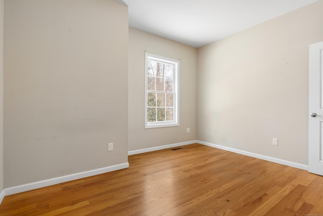 unfurnished room featuring light wood-type flooring and baseboards