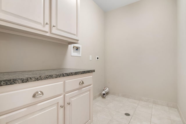 laundry room with light tile patterned floors, washer hookup, baseboards, cabinet space, and electric dryer hookup