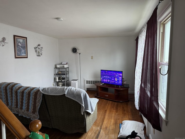 living area featuring radiator and wood finished floors