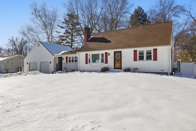 view of front of property with a garage, a shingled roof, and a chimney