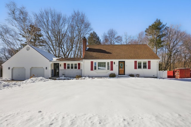 ranch-style house with a chimney and an attached garage