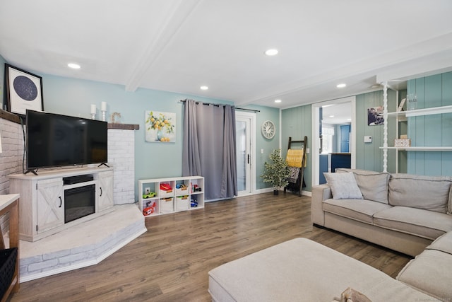 living area featuring recessed lighting, dark wood-style flooring, a fireplace, baseboards, and beam ceiling