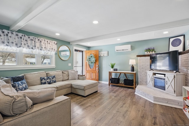 living room featuring a wall unit AC, recessed lighting, wood finished floors, beamed ceiling, and baseboards