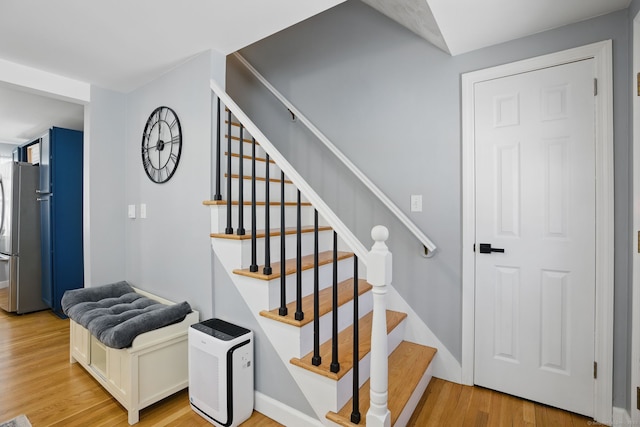 stairway featuring wood finished floors