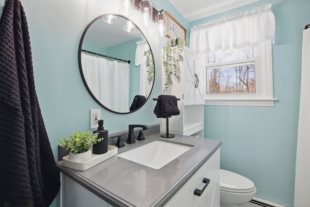 bathroom featuring a baseboard radiator, vanity, and toilet