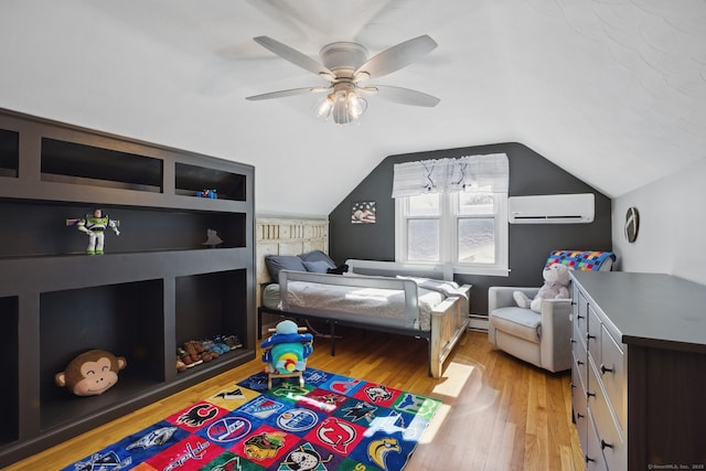 bedroom with lofted ceiling, ceiling fan, a wall unit AC, light wood-style flooring, and baseboard heating