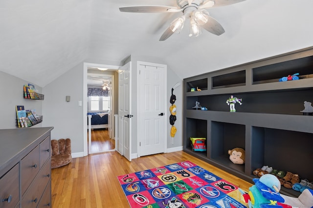 bedroom featuring vaulted ceiling, ceiling fan, light wood finished floors, and baseboards