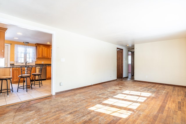 living room with light wood-type flooring and baseboards