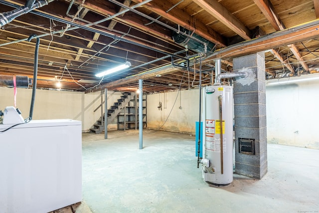 unfinished basement featuring stairs, gas water heater, and washer / dryer