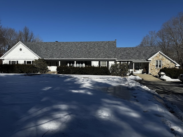 ranch-style house with stone siding