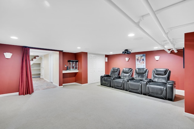 carpeted home theater room with recessed lighting and baseboards