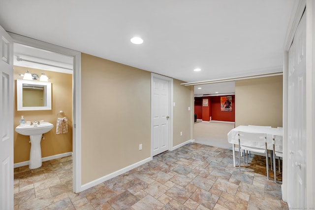 interior space featuring stone finish flooring, baseboards, and recessed lighting