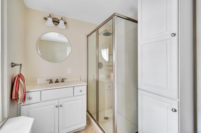 bathroom with a shower stall and vanity