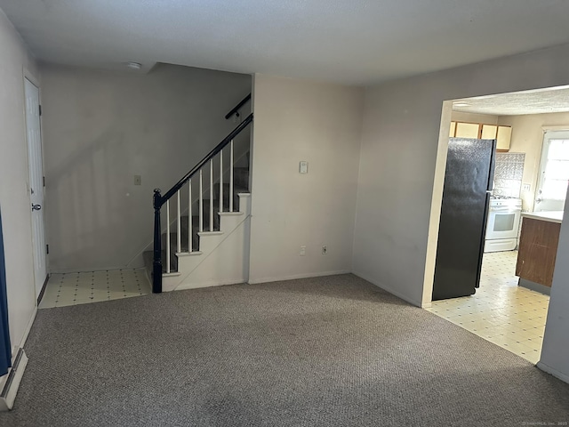 interior space with light carpet, light floors, and stairway