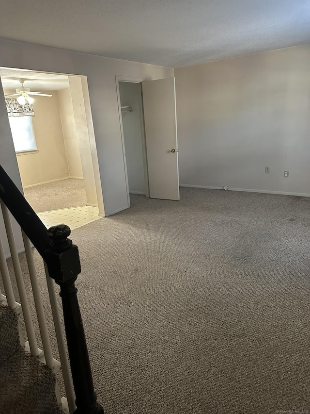 carpeted spare room with stairway