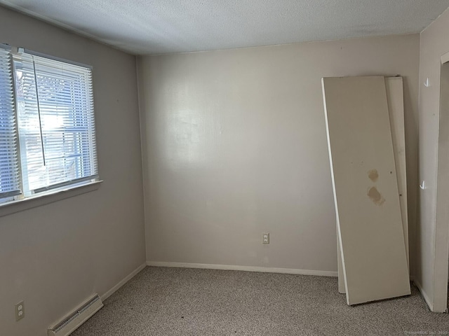 empty room with baseboards, visible vents, a textured ceiling, and light colored carpet