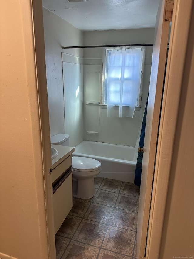 full bathroom with shower / tub combination, vanity, toilet, and tile patterned floors