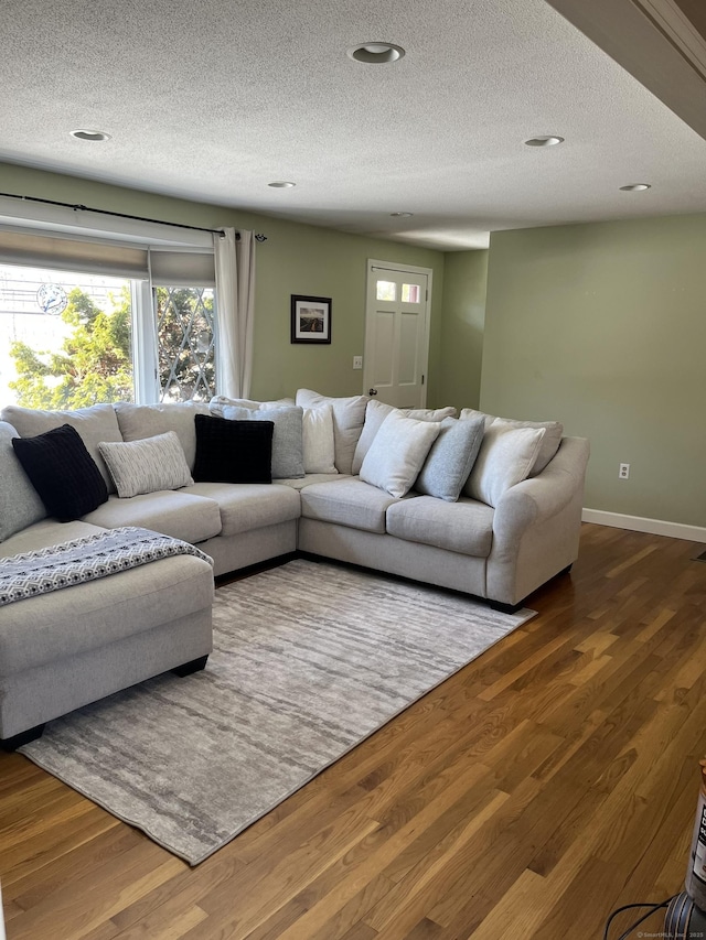 living room featuring hardwood / wood-style flooring and a textured ceiling