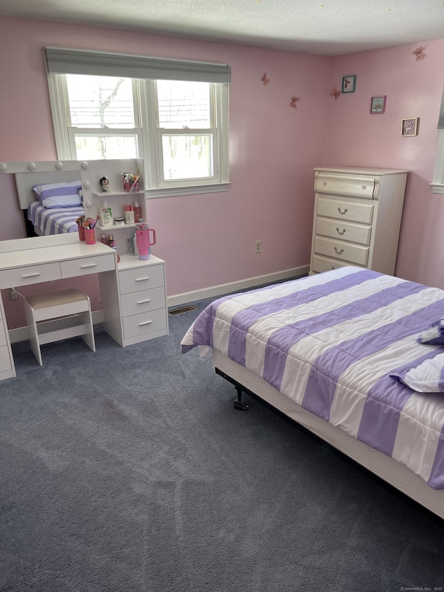 bedroom featuring carpet and a textured ceiling