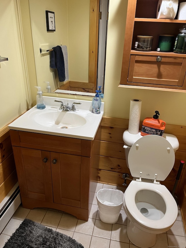 bathroom with tile patterned floors, toilet, vanity, and a baseboard radiator