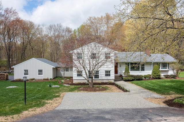 view of front of house with board and batten siding and a front yard