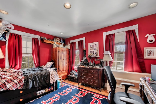 bedroom with recessed lighting and wood finished floors