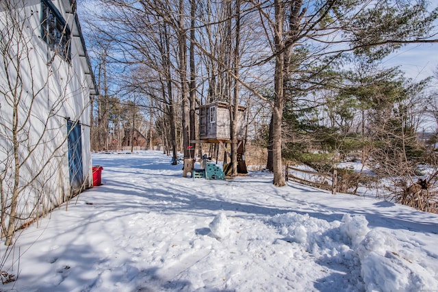 yard covered in snow with a playground