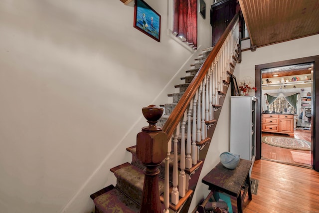 stairs featuring wood-type flooring