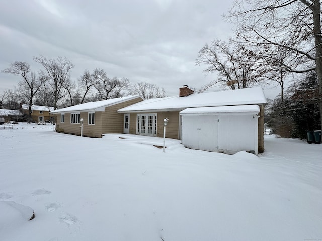 159 Tom Swamp Rd, Hamden, CT 06518 - view of front of house featuring a garage, french doors, and a chimney